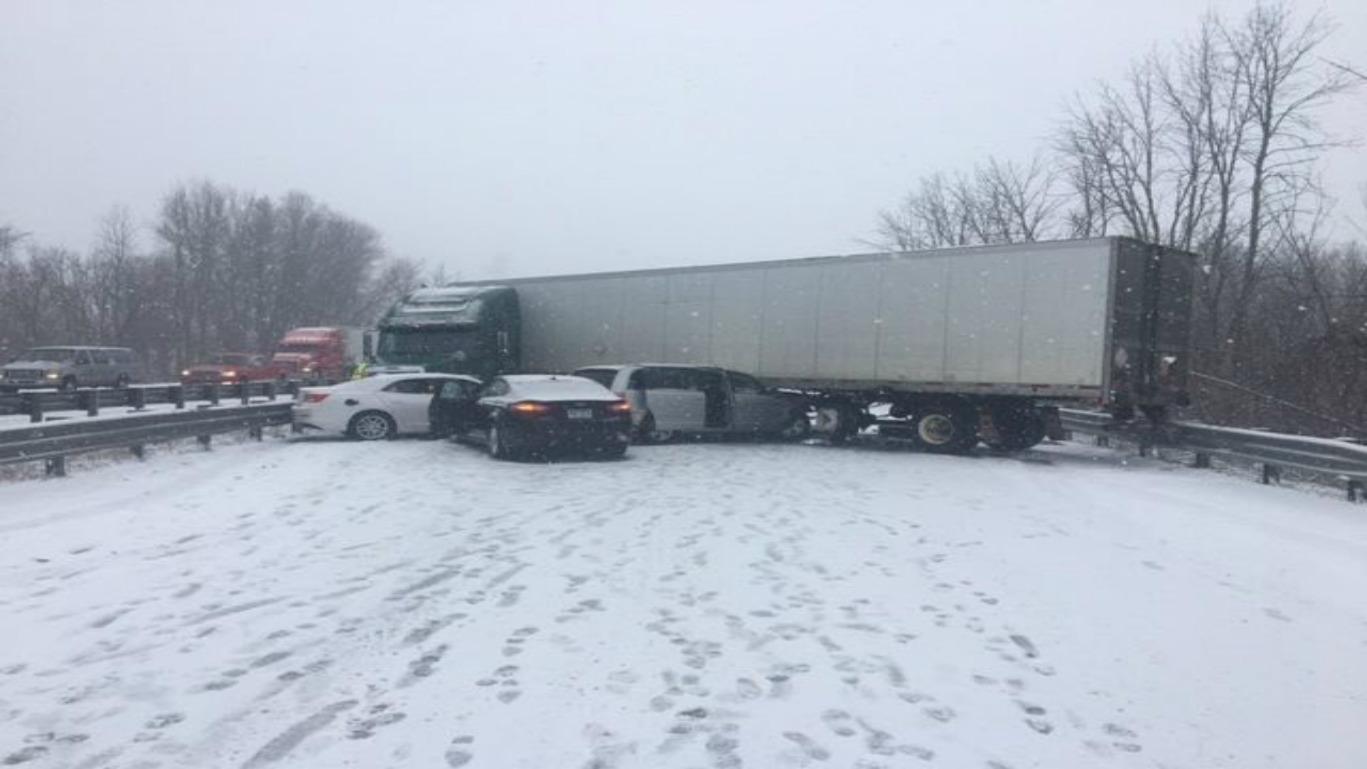 Dispatch Car stuck under jackknifed semitruck, highway shutdown